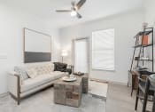 Thumbnail 1 of 35 - a living room with a couch and a coffee table