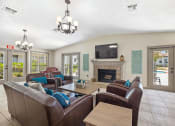 Thumbnail 32 of 34 - a living room with a rug and a fireplace