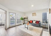 Thumbnail 2 of 40 - A living room with a grey couch and a white coffee table.
