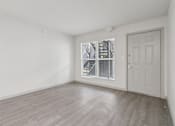 Thumbnail 11 of 38 - A room with a white door and a window with blinds.