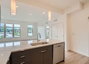 Thumbnail 5 of 22 - a kitchen with white walls and white countertops