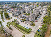 Thumbnail 24 of 28 - A bird's eye view of a residential area with houses and cars.