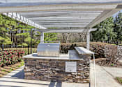 Thumbnail 8 of 31 - A stone structure with a metal roof and a sign on it.