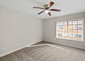 Thumbnail 43 of 54 - A room with a ceiling fan and a window with blinds.
