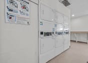 Thumbnail 5 of 11 - a white kitchen with a row of white refrigerators in it