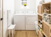 Thumbnail 25 of 30 - a small laundry room with a washer and dryer