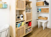 Thumbnail 26 of 30 - a storage unit with baskets and baskets on the shelves and a stool next to it