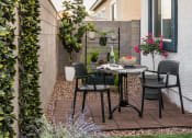 Thumbnail 11 of 30 - a small patio with a table and chairs
