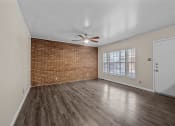 Thumbnail 6 of 11 - an empty living room with a ceiling fan and a window