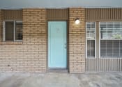 Thumbnail 11 of 11 - the front of a brick building with a blue door