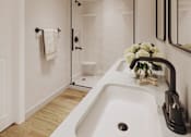 Thumbnail 4 of 16 - A white sink in a modern bathroom with a glass shower door.