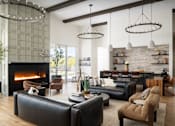 Thumbnail 12 of 21 - A modern living room with a fireplace and a variety of seating options.