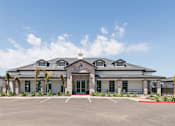 Thumbnail 15 of 20 - A building with a parking lot in front of it.