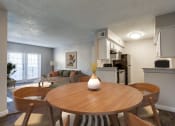 Thumbnail 4 of 20 - an open living room and dining room with a table and chairs