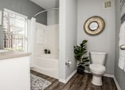 Thumbnail 10 of 28 - a bathroom with a toilet and a bath tub