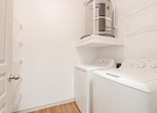 Thumbnail 20 of 41 - a laundry room with a washer and dryer and a coffeemaker in