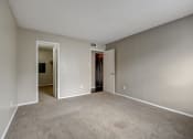 Thumbnail 15 of 26 - a bedroom with a carpeted floor and an open doorway