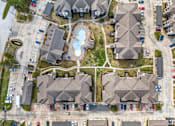 Thumbnail 22 of 28 - A bird's eye view of a residential area with houses and a swimming pool.
