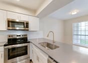 Thumbnail 3 of 28 - a kitchen with white cabinets and stainless steel appliances