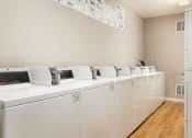 Thumbnail 34 of 37 - a laundry room with washers and dryers