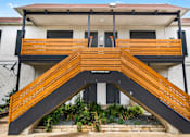 Thumbnail 21 of 22 - a building with a ramp with wooden benches
