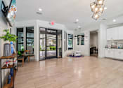 Thumbnail 29 of 38 - A spacious living room with a kitchen area in the background.