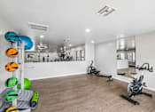 Thumbnail 19 of 26 - A gym with exercise equipment and a mirror on the wall.