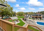 Thumbnail 1 of 10 - a view of the backyard of a community with a pool and buildings
