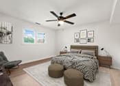 Thumbnail 9 of 10 - a bedroom with a bed and a ceiling fan