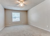 Thumbnail 12 of 19 - an empty room with a ceiling fan and a window