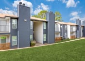 Thumbnail 15 of 19 - a row of townhomes with gray roofs and green grass