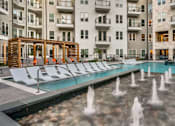 Thumbnail 16 of 26 - A pool with a fountain in the middle of it.
