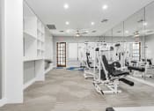 Thumbnail 19 of 20 - a gym with cardio machines and weights on the floor