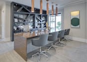 Thumbnail 26 of 36 - A modern kitchen with a long island and chairs.