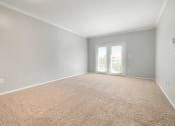 Thumbnail 5 of 37 - a bedroom with gray walls and a carpeted floor