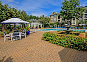 Thumbnail 19 of 25 - A pool area with a gazebo and chairs.
