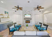 Thumbnail 18 of 30 - A living room with a fireplace and a television.