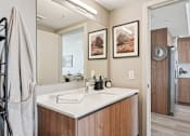 Thumbnail 15 of 26 - A bathroom with a white sink and a towel rack.