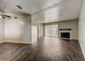 Thumbnail 20 of 36 - a living room with hardwood floors and a fireplace