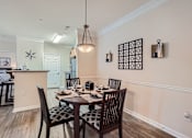 Thumbnail 8 of 37 - A dining room with a table set for six.