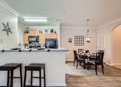 Thumbnail 13 of 37 - A kitchen with a bar and a dining table.