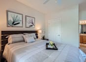 Thumbnail 16 of 37 - A bedroom with a large bed and two framed pictures on the wall.