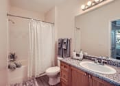 Thumbnail 19 of 37 - A bathroom with a toilet, sink, and shower.