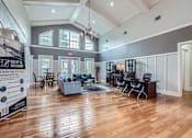 Thumbnail 36 of 37 - A spacious living room with hardwood floors and a variety of seating options.
