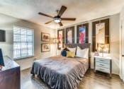 Thumbnail 3 of 16 - a bedroom with a large bed and a ceiling fan