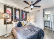 Thumbnail 4 of 16 - a bedroom with a large bed and a ceiling fan
