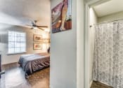 Thumbnail 6 of 16 - the master bedroom has a ceiling fan and a sliding door to the bathroom