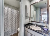 Thumbnail 7 of 16 - a bathroom with a sink and a shower and a toilet