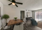 Thumbnail 4 of 36 - an open living room and dining room with a table and chairs and a ceiling fan