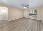 Thumbnail 4 of 17 - a bedroom with a ceiling fan and a window